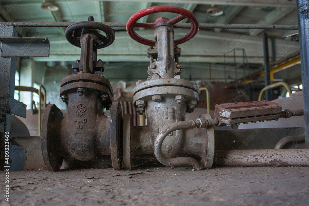 Abandoned boiler house, rusty steam boiler during demolition.