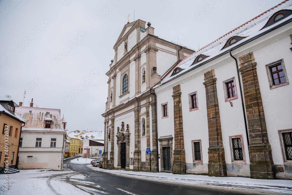 The Augustinian baroque monastery with the Basilica of All Saints, abbey in Bohemia under snow in winter day, Ceska Lipa, North Bohemia, Czech Republic