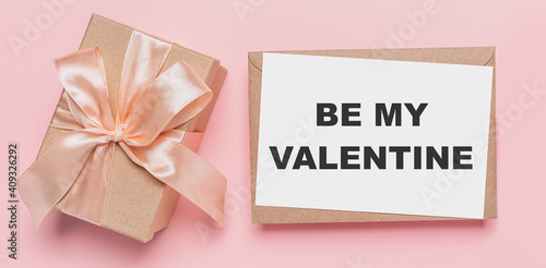 Gifts with note letter on isolated pink background, love and valentine concept with text be my Valentine