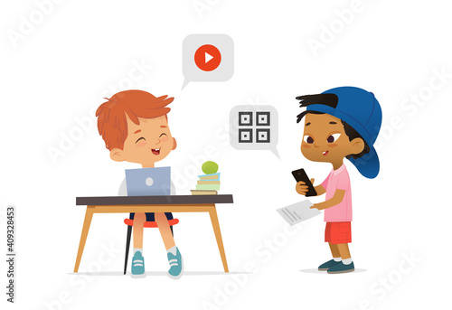Asian American Boy scanning a code on their phone from a booklet and greeting classmate sitting at table and watching video.