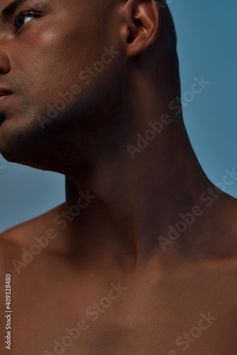 Sportsperson showing his neck in an isolated studio