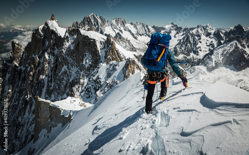 Man climbing through the mountains on snow and glacier