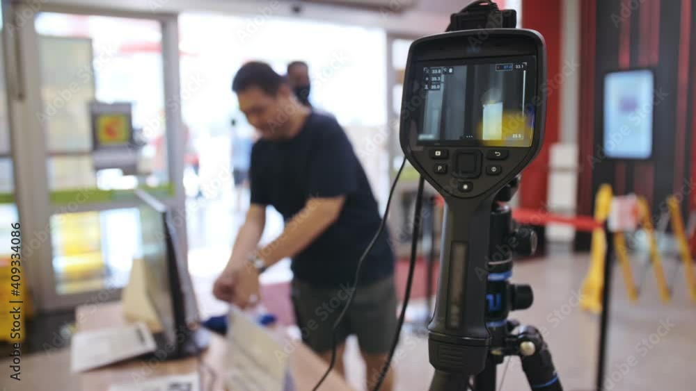 Temperature Check Commercial Temperature check at a supermarket, grocery store with a thermal ...