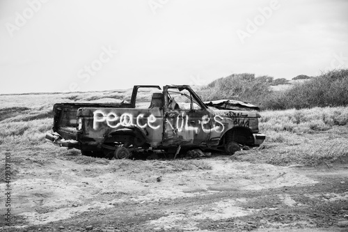 off road vehicle burned and graffitied  Peace Rules 