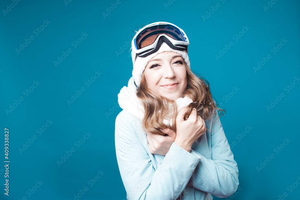 cheerful young woman in a hat and ski mask. A girl in a winter jacket cheerful young woman in a hat and ski mask. A girl in a winter jacket