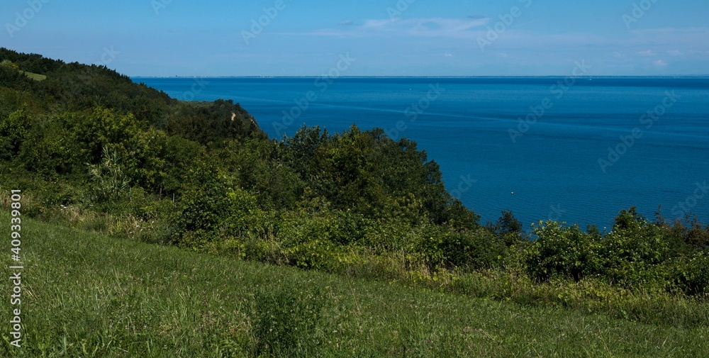View of the endless sea horizon from the hilly coast. 
