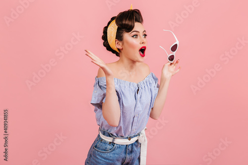 Konstfotografi Shocked pinup girl holding sunglasses
