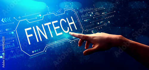 Fintech concept with hand pressing a button on a technology screen