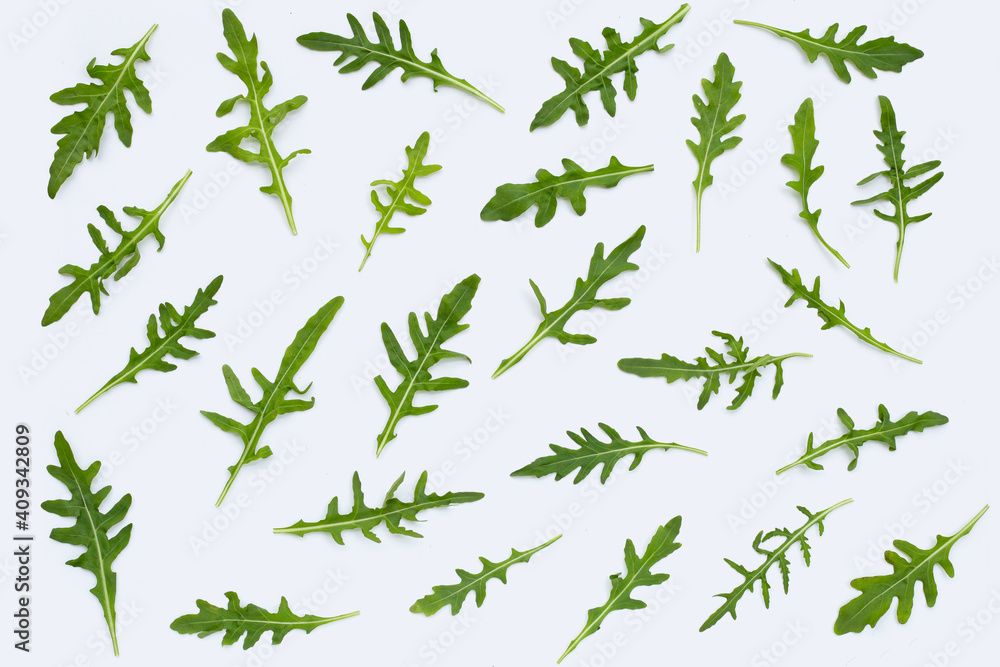 Fresh green rocket salad on white background.