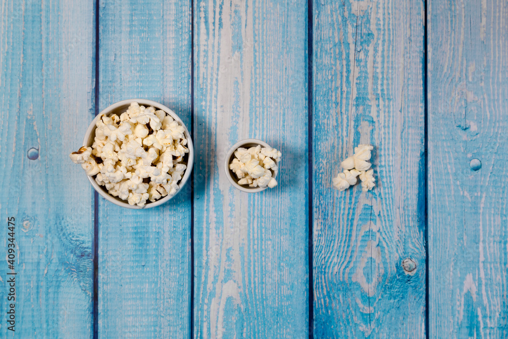 Popcorn bowls on blue wooden table. Popcorn bowls on blue wooden table.