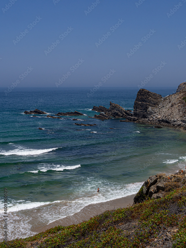 Empty beach with waves and blue water, paradise, in costa vicentina, alentejo, portugal	