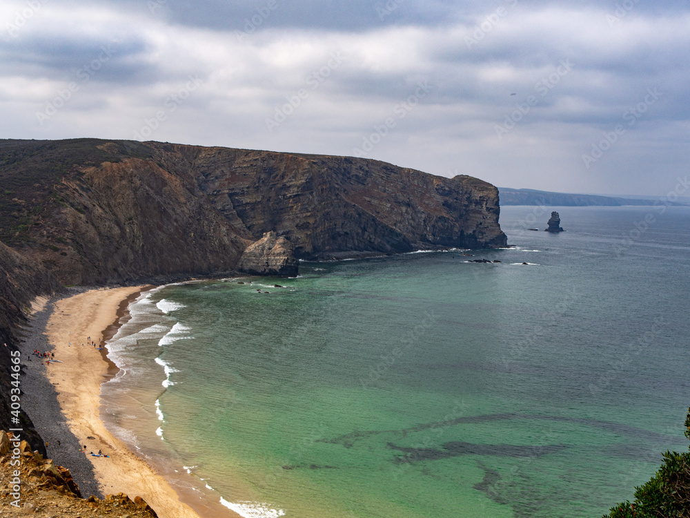 Paradise empty beach with blue and green water and cliffs in costa vicentina, alentejo, portugal Paradise empty beach with blue and green water and cliffs in costa vicentina, alentejo, portugal