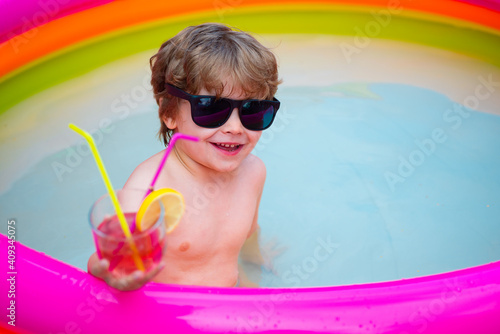Cool happy holidays. Kid in the home pool. Cocktail.