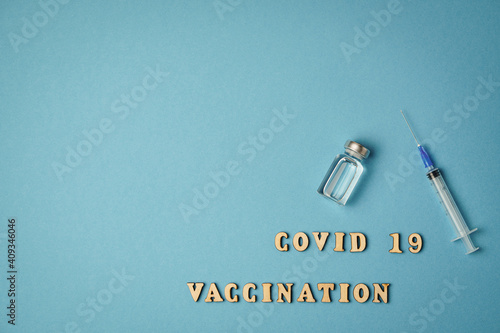 Copy space nscription covid 19 vaccination, vaccine, syringe on blue background