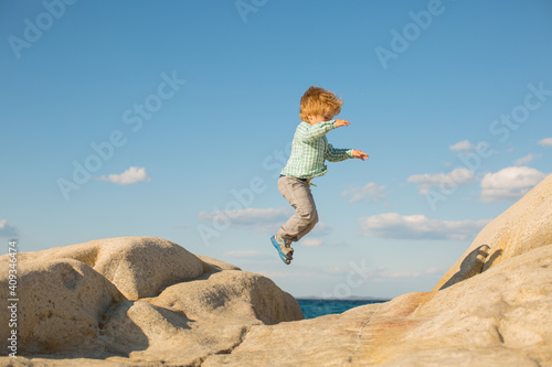 Happy jump. Children holidays at the beach.