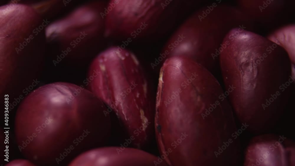 Rotating peanuts close up. Raw peanuts in red skin in motion. Rotating peanuts close up. Raw peanuts in red skin in motion.