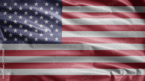 American flag waving in the wind. Close up of USA banner blowing, soft silk.