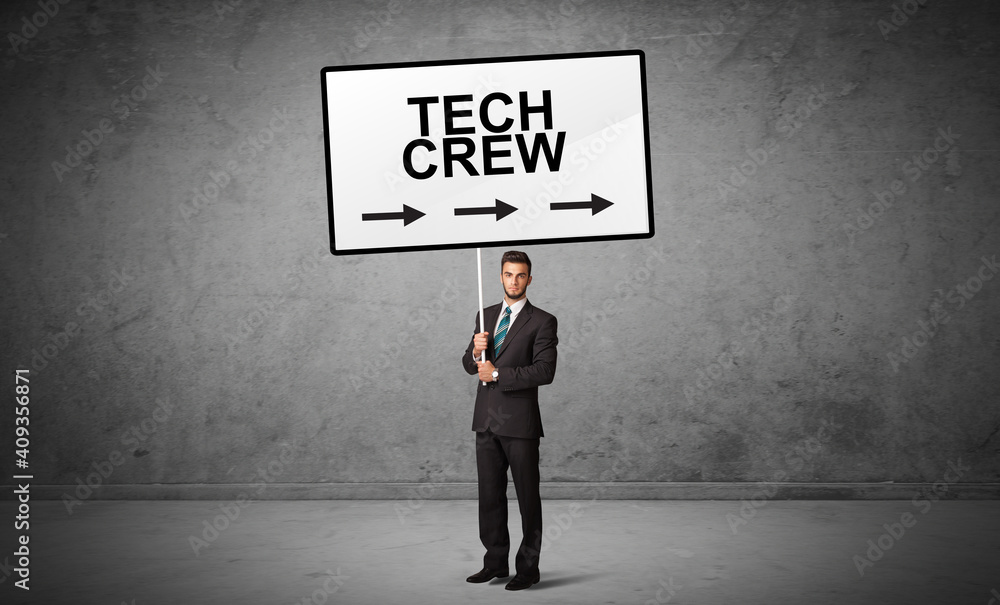business person holding a traffic sign with TECH CREW inscription, new idea concept business person holding a traffic sign with TECH CREW inscription, new idea concept