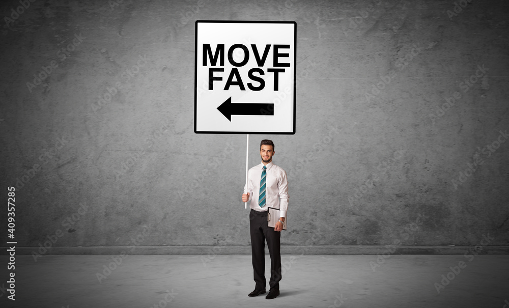 business person holding a traffic sign with MOVE FAST inscription, new idea concept business person holding a traffic sign with MOVE FAST inscription, new idea concept
