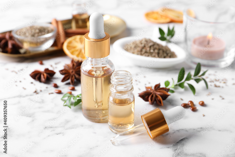 Anise essential oil and spice on white marble table Anise essential oil and spice on white marble table