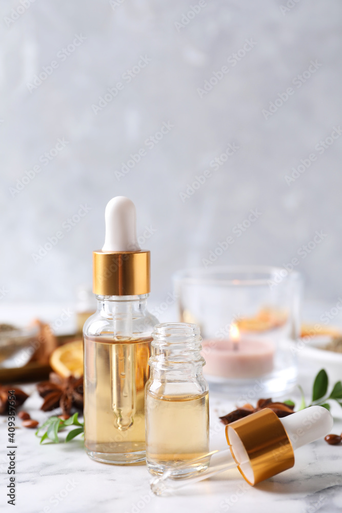 Anise essential oil and spice on white table Anise essential oil and spice on white table