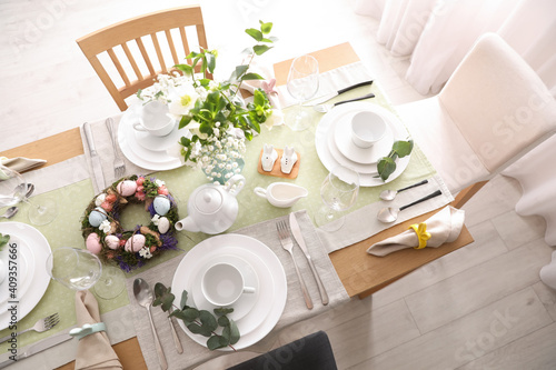 Beautiful Easter table setting with festive decor indoors, above view