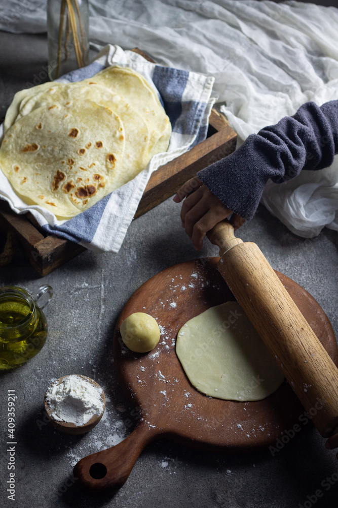 Fototapeta premium Homemade Kulit Kebab or Tortilla wrap on blue white napkin on wooden rustic tray. 