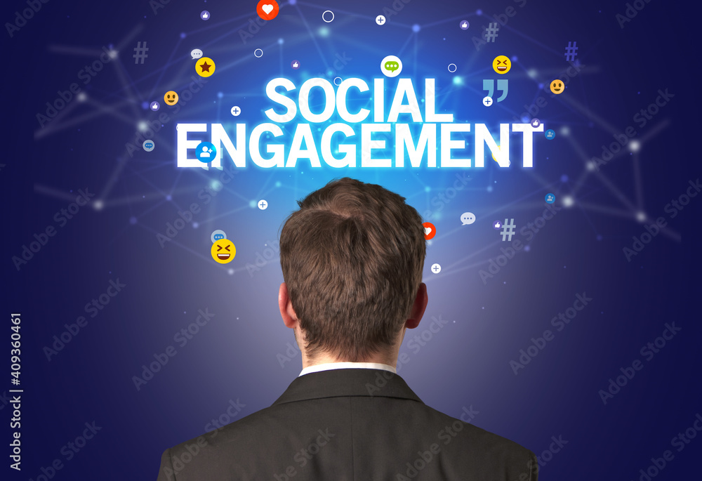 Rear view of a businessman with SOCIAL ENGAGEMENT inscription, social networking concept Rear view of a businessman with SOCIAL ENGAGEMENT inscription, social networking concept