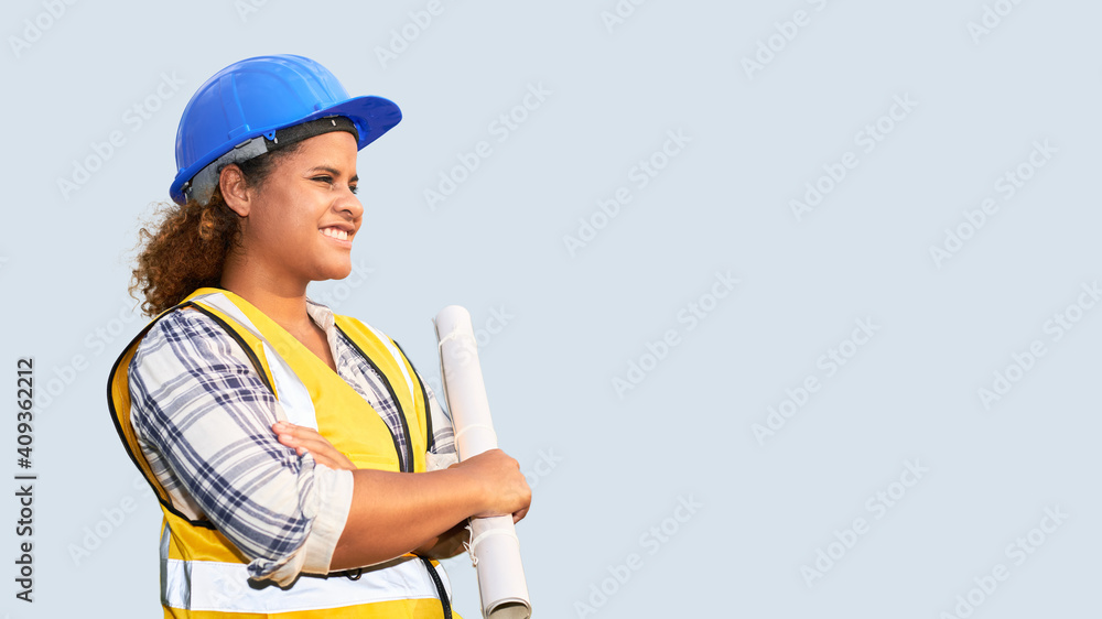 Fototapeta premium Portrait of African American woman architect wearing a vest and helmet on isolated background.