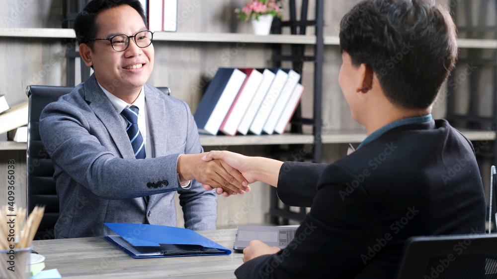 Asian men handshake successfully in job interview at office background, job search, business concept Asian men handshake successfully in job interview at office background, job search, business concept
