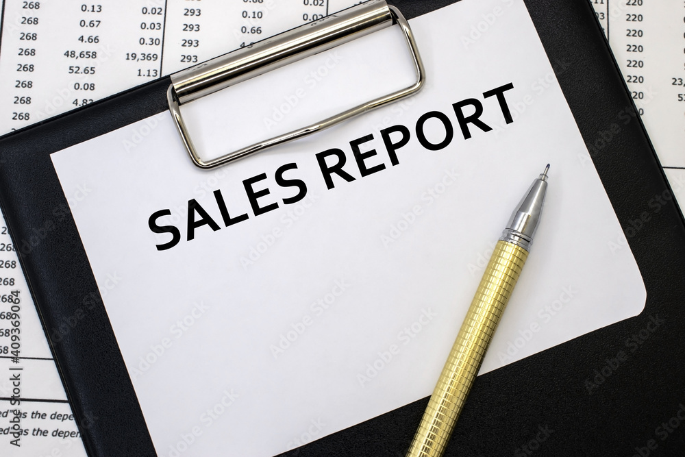 The sales report is written on a stationery tablet. Business documents. Business and financial concept The sales report is written on a stationery tablet. Business documents. Business and financial concept