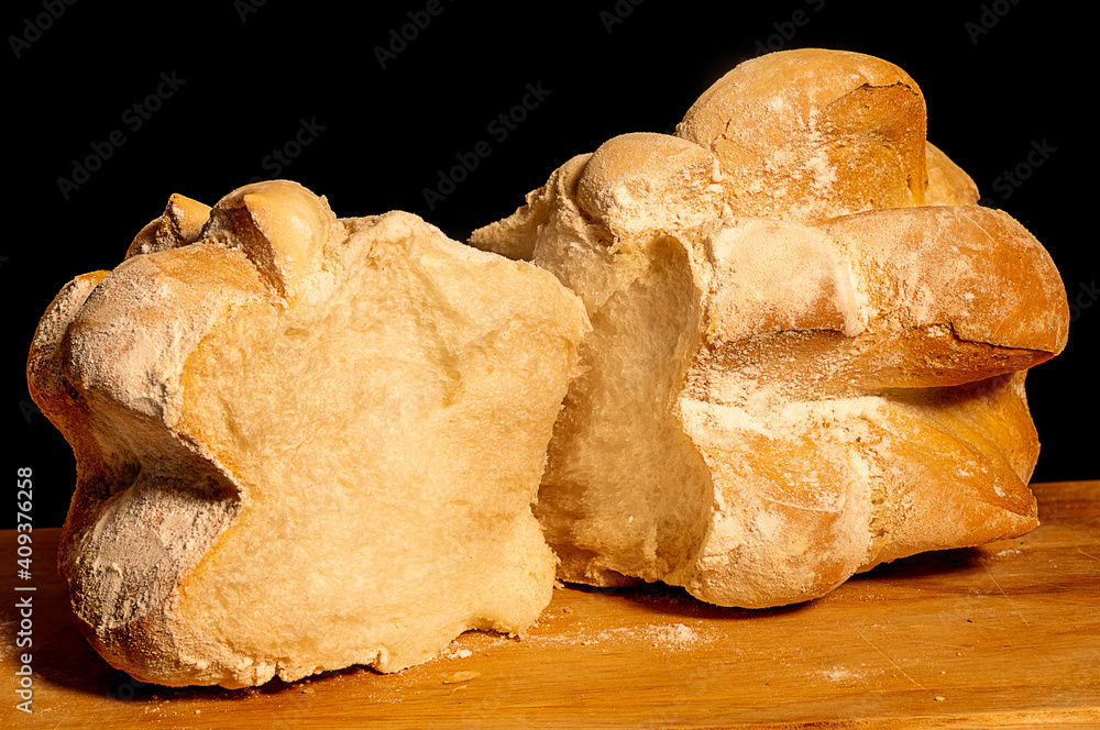 Close up of an Homemade bread in the wooden cutting board - Black underground
Close up of an Homemade bread in the wooden cutting board - Black underground