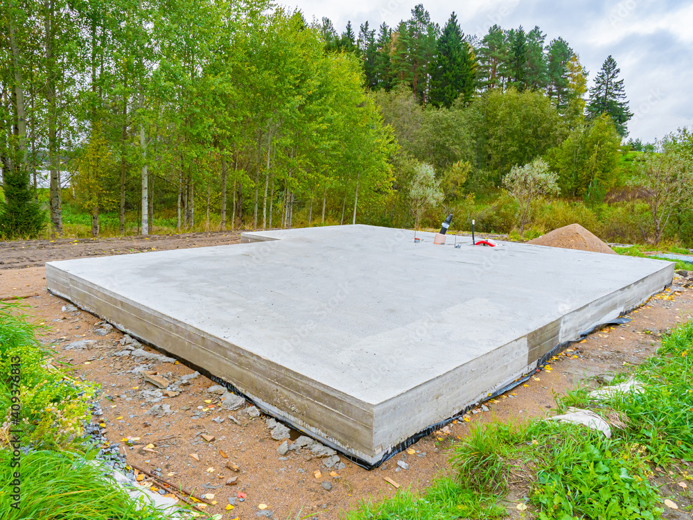 Concrete foundation next to trees. Construction near forest ...