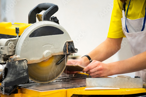 Man processes ceramic tiles...