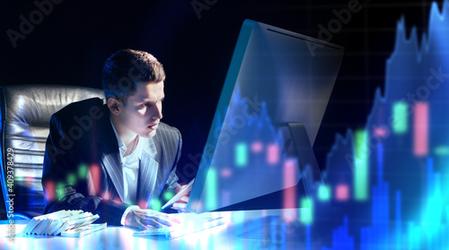 Trader next to computer. Gr...