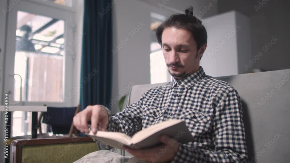 the guy flips through the pages of the book