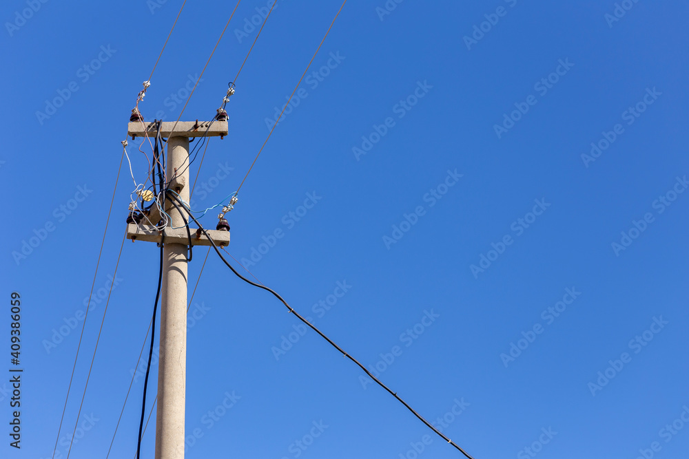 Old electricity pole and blue sky in Turkey.