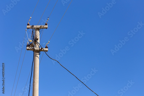 Old electricity pole and blue sky in Turkey.