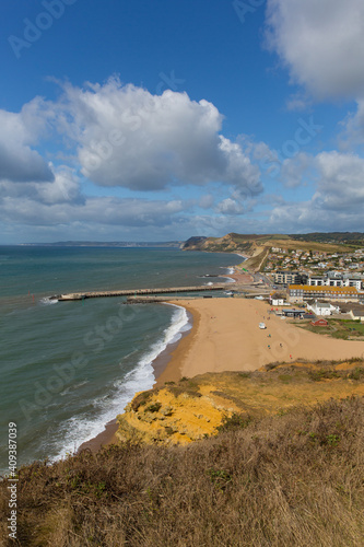 West Bay beach Dorset uk sandstone cliff with beach and waves