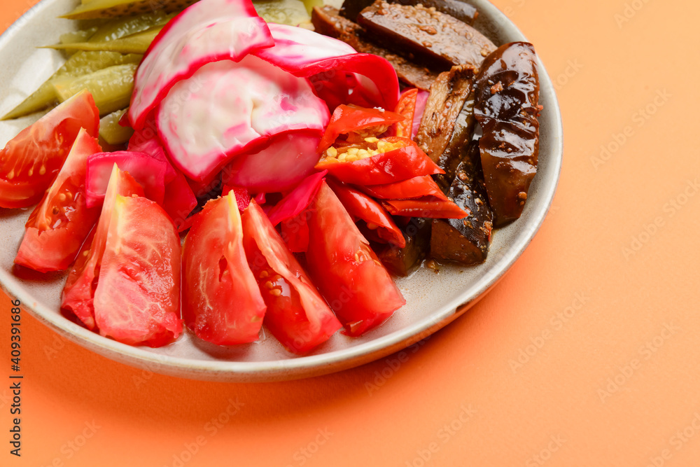 Preserved vegetables cut and served on a white plate. Pickled cucumbers, tomatoes, cabbage. Preserved vegetables cut and served on a white plate. Pickled cucumbers, tomatoes, cabbage.