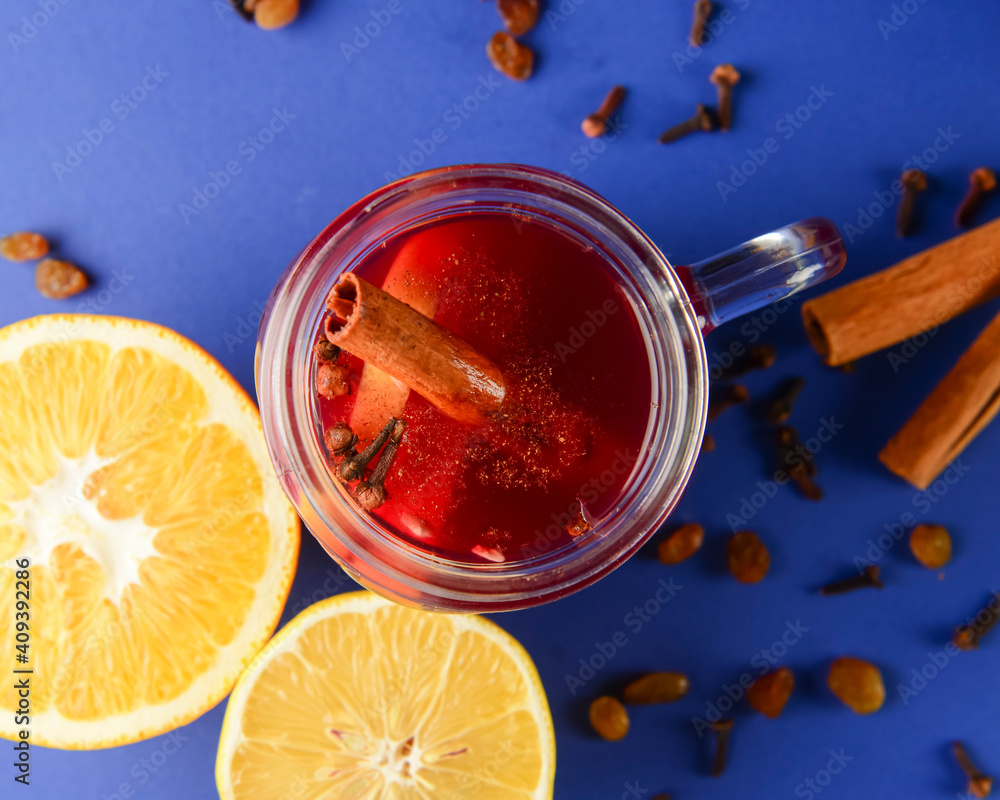 Homemade honey, cinammon and lemon tea in mason jar over blue background. Homemade honey, cinammon and lemon tea in mason jar over blue background.