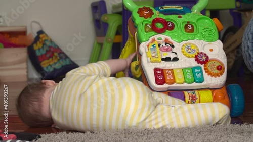 A young baby playing with a toy, learning motorskills. photo