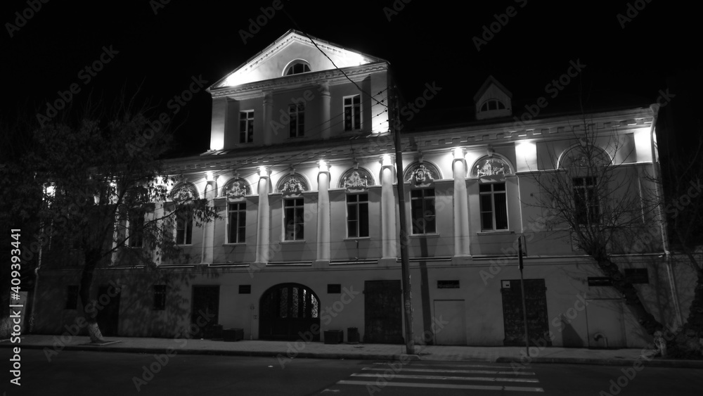 
The facade of the building at night under the light of street lamps