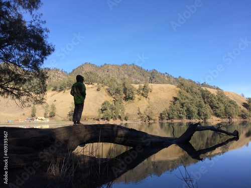 Man Standing Alone on the Edge of the Lake