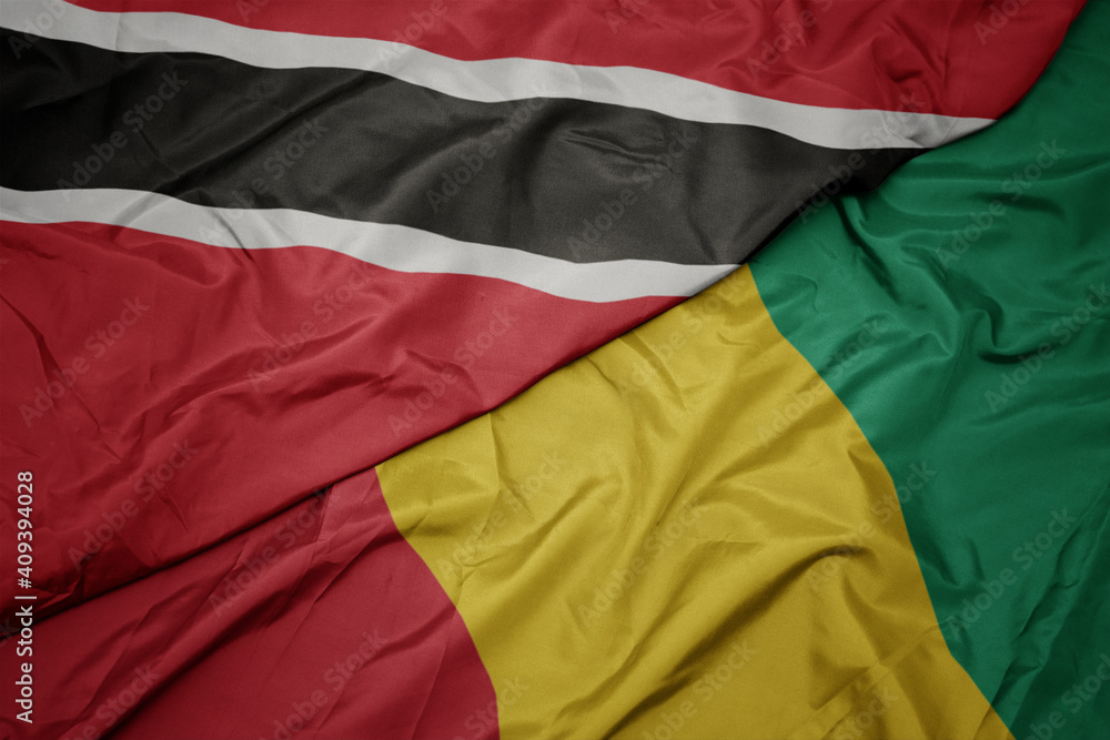 waving colorful flag of guinea and national flag of trinidad and tobago.