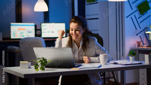 фотографія Excited young woman winner looking at laptop celebrate online win success reading great news using laptop feel amazed working overtime in start up business office