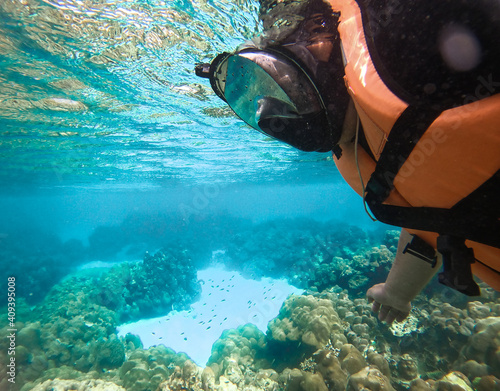 Man snorkelling underwater with snorkel mask. © Skies Clear