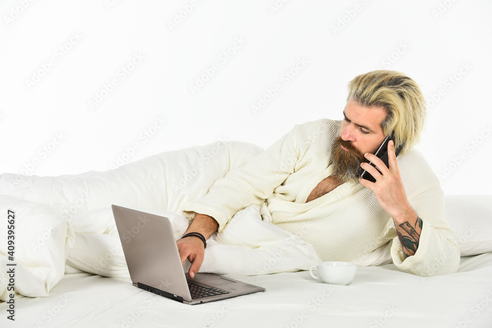 Modern life. Social networks dependence. Screen Time and Insomnia. Happy hipster drink coffee in bed. Bearded man enjoy coffee and surfing internet laptop. Morning coffee routine. Social media Modern life. Social networks dependence. Screen Time and Insomnia. Happy hipster drink coffee in bed. Bearded man enjoy coffee and surfing internet laptop. Morning coffee routine. Social media