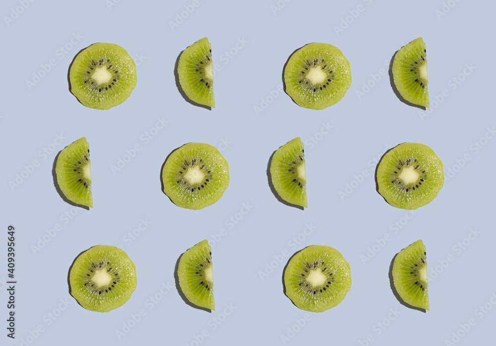 Fototapeta premium Kiwi isolated on blue background. Half of kiwi. Kiwi pattern. Food photography.