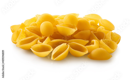raw pasta conchiglie on white isolated background